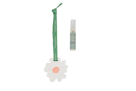 Small bottle with a green strap and white daisy charm on a white background