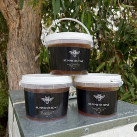 3 tubs of honey on top of a hive