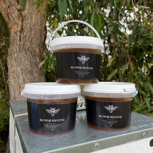 3 tubs of honey on top of a hive