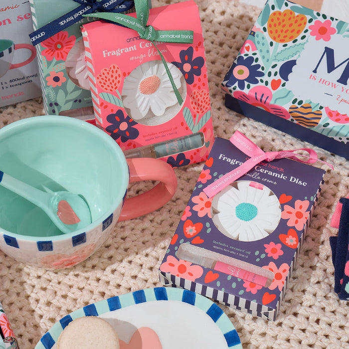 Assorted children's products including cups, plates, and decorative items on a textured surface.