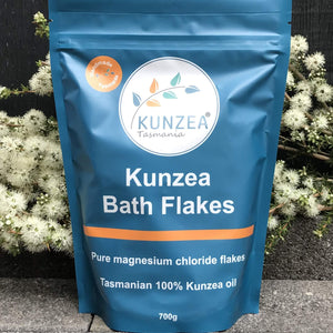 Kunzea Bath Flakes packaging with Kunzea Tasmania logo against a natural background