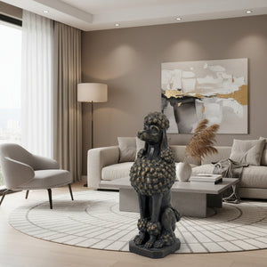 A dark bronze-finished statue of a poodle sitting upright on a rectangular base, photographed against a plain white background.