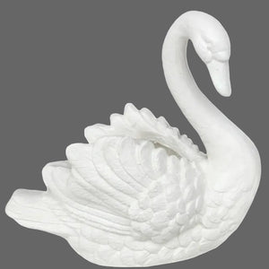White ceramic swan figurine on a white background