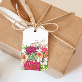 Gift wrapped in brown paper with a floral tag on a light background