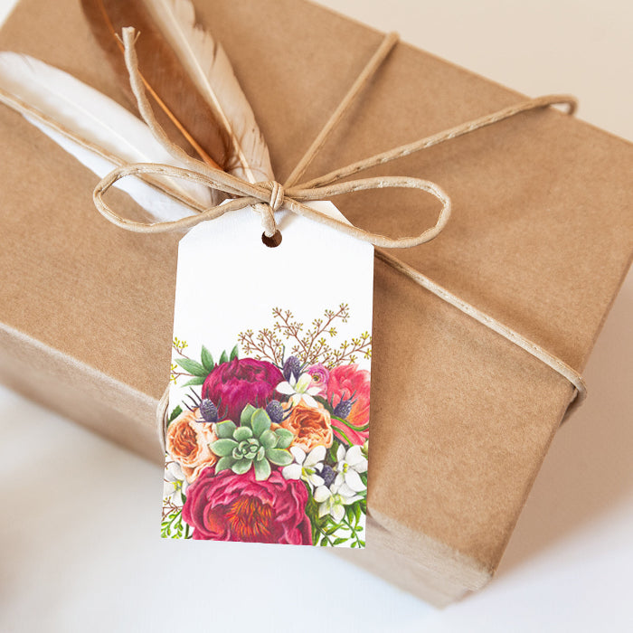 Gift wrapped in brown paper with a floral tag on a light background