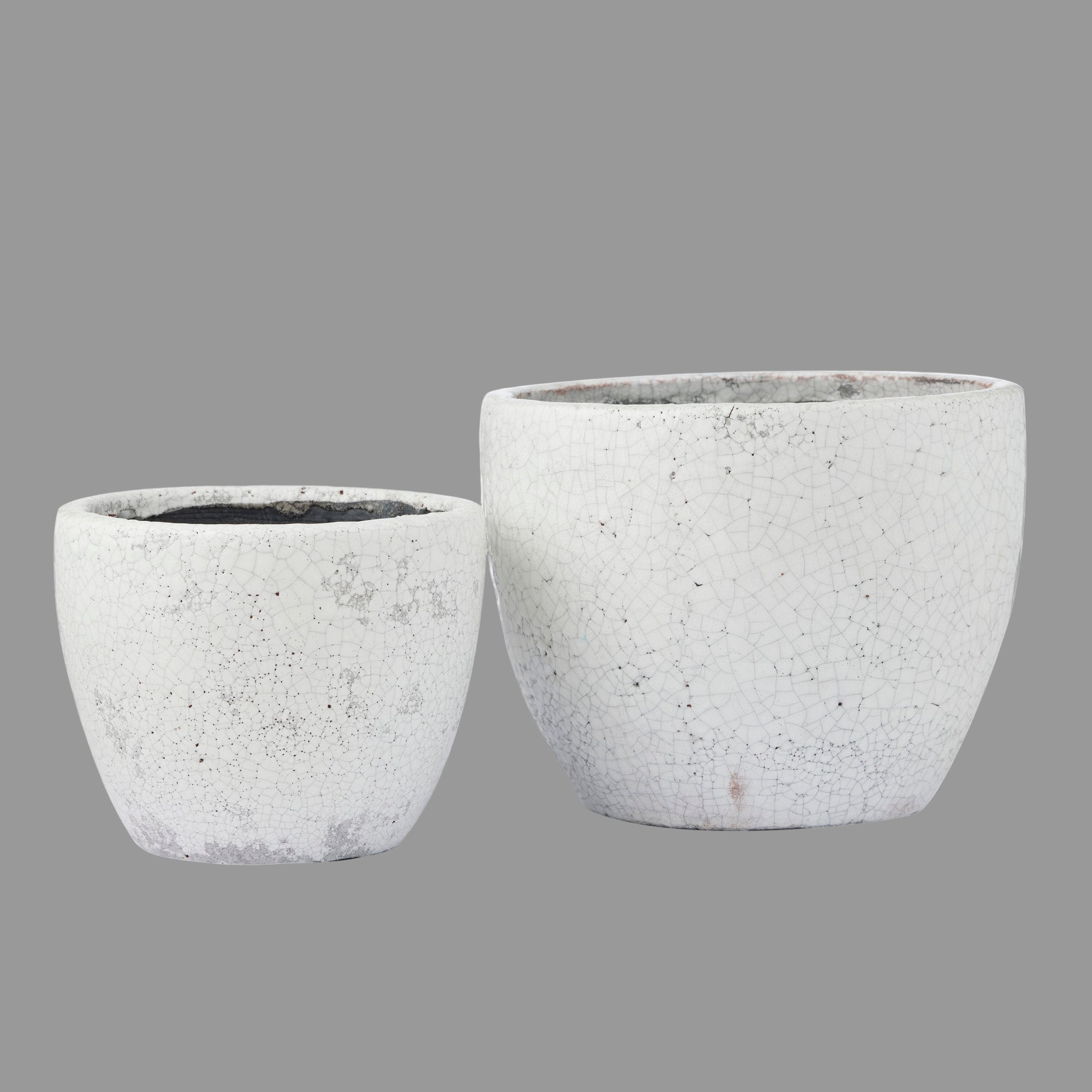 Two gray concrete planters on a white background