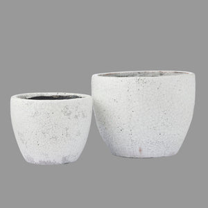 Two gray concrete planters on a white background