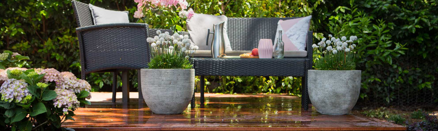 Outdoor furniture set with chairs, table, and decorative elements on a wooden deck.