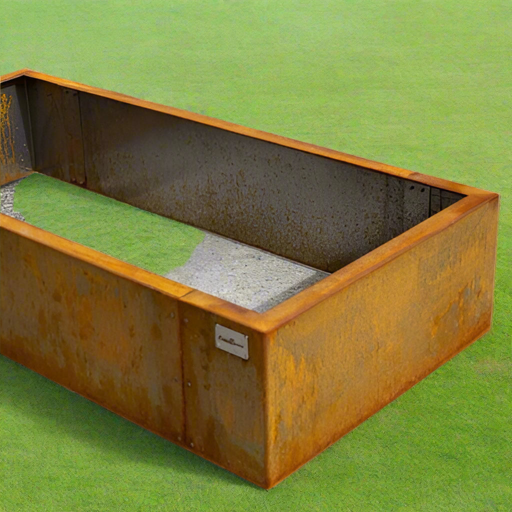 Rust-colored metal planter box on a concrete surface