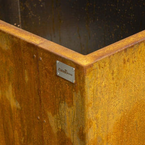 Rust-colored metal surface with a brand label on a dark background