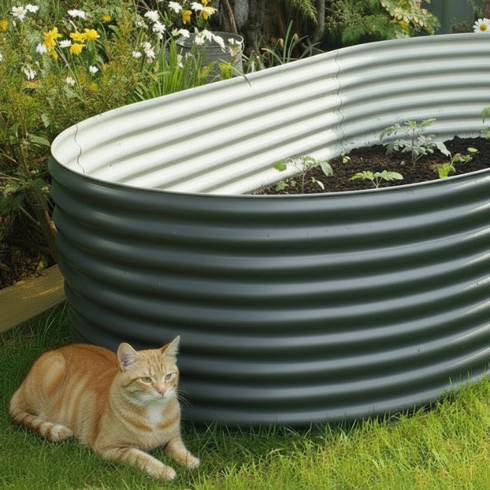 Corrugated metal water tank in a garden setting with plants and flowers.