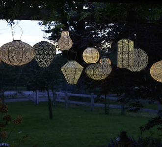 Decorative string lights hanging in a garden at night