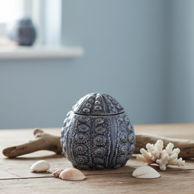 A small decorative lidded box with an intricate embossed floral and geometric pattern, shown on a plain white background.