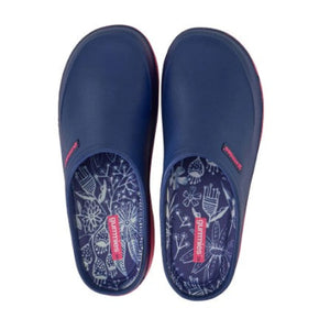 Pair of navy blue clogs with floral patterns on a white background