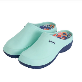 Pair of light blue clogs with floral design on a white background
