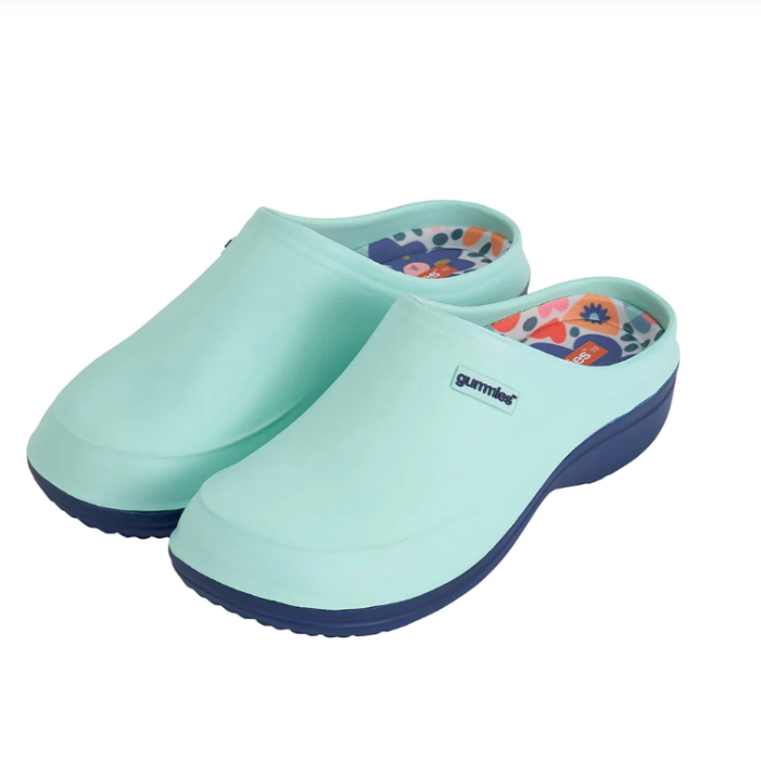 Pair of light blue clogs with floral design on a white background