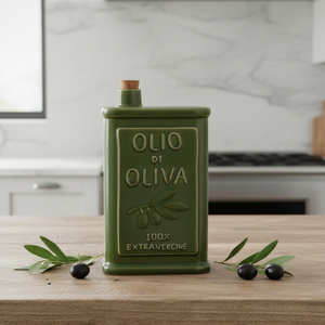 A green ceramic olive oil bottle with a cork stopper, featuring embossed text that reads 'OLIO DI OLIVA' and '100% EXTRAVERGINE' on a plain white background.