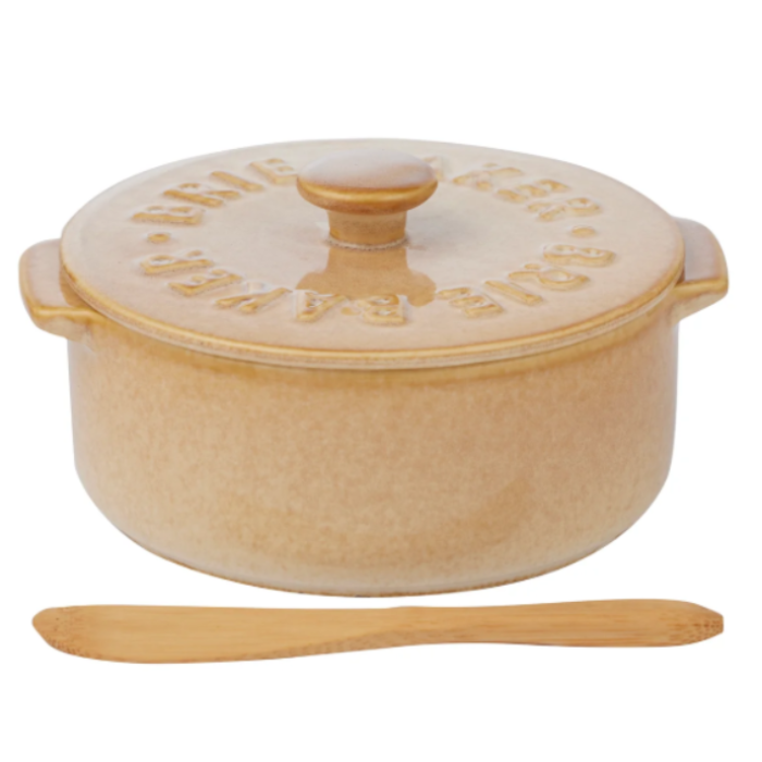 A beige ceramic Dutch oven with a matching lid, embossed with the brand name 'Duisberg', shown with a wooden spoon on a white background.