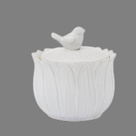 White ceramic pot with textured design and small bird on top against a white background