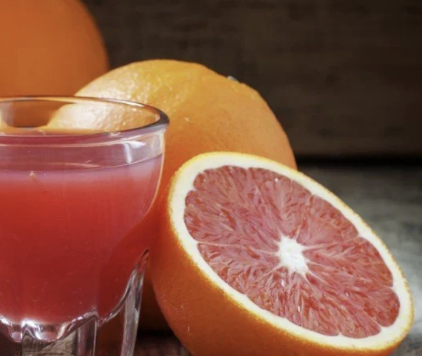 cut orange and glass of juice