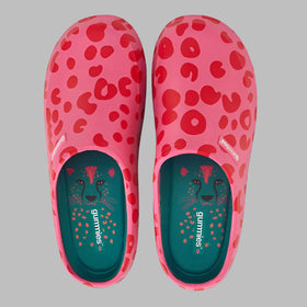 Pair of pink clogs with red heart pattern on a white background
