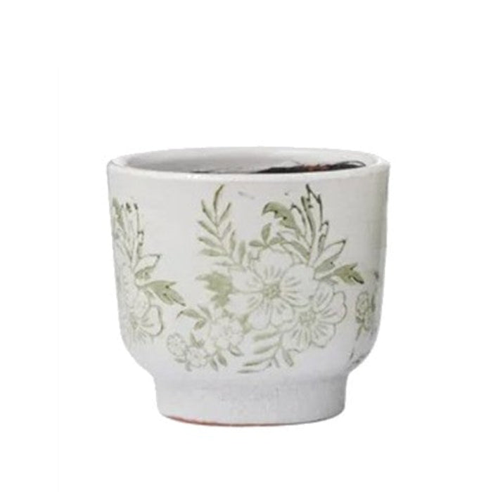 Ceramic planter with floral design on a white background