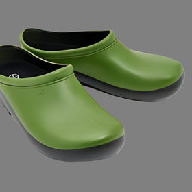 Green rubber clogs with black soles on a white background