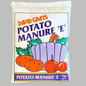 A bag of David Grays Potato Manure E, featuring illustrations of potatoes and carrots on the front, with a label indicating 3kg weight.