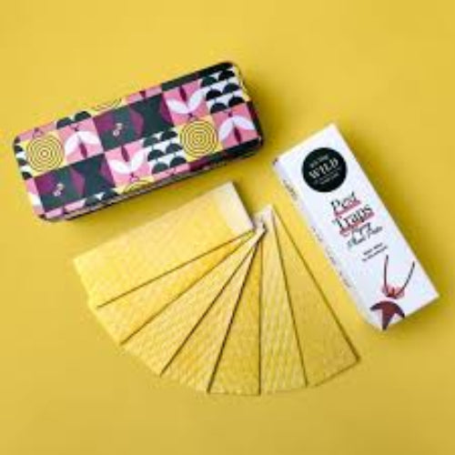 Packaged cookies with a box of tea on a yellow background