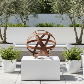 A rusted metal decorative sphere with intersecting circular bands, photographed on a clean white background.