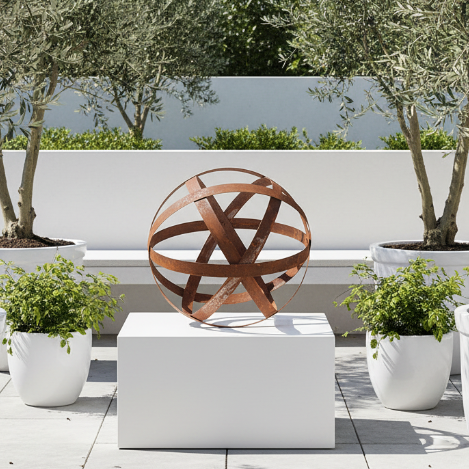 A rusted metal decorative sphere with intersecting circular bands, photographed on a clean white background.