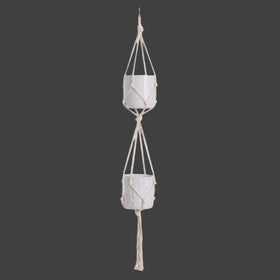 Macrame plant hanger with two ceramic pots on a white background