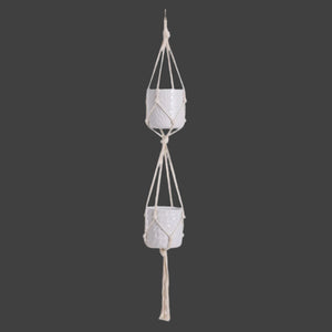 Macrame plant hanger with two ceramic pots on a white background