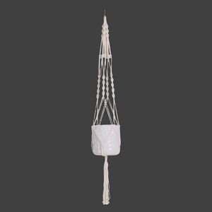Macrame plant hanger with a decorative pot on a black background