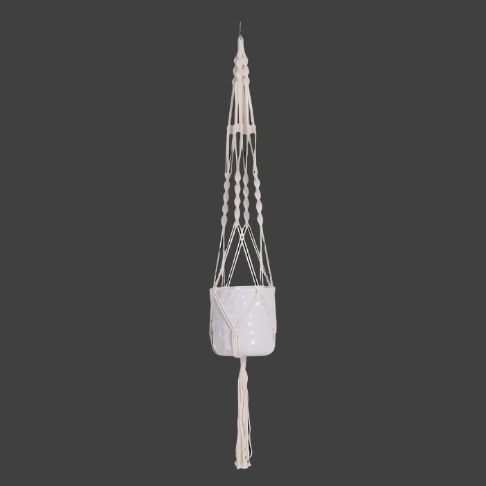 Macrame plant hanger with a decorative pot on a black background