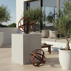 A spherical metal sculpture made of interlaced rusted brown bands, photographed on a clean white background.