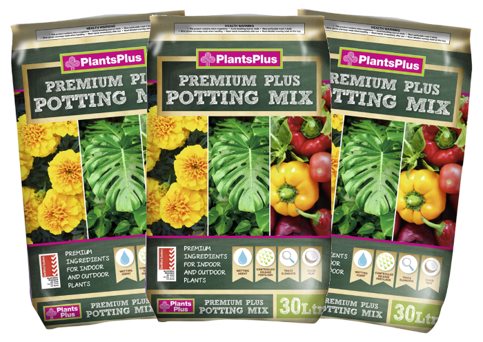 Three packages of PlantsPlus Premium Plus Potting Mix with images of plants on the packaging.