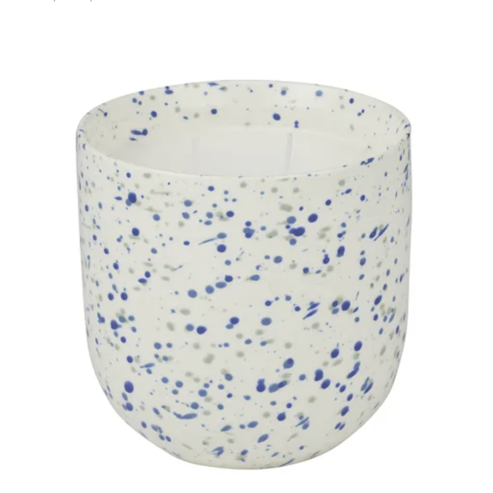 Speckled ceramic cup with blue and gray specks on a white background