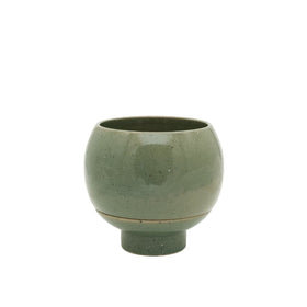 Green ceramic cup on a white background