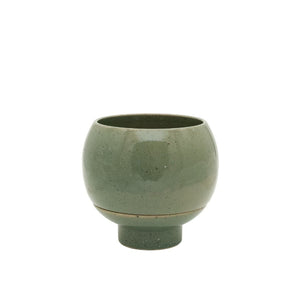 Green ceramic cup on a white background