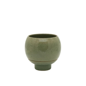 Green ceramic cup on a white background