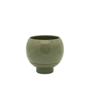 Green ceramic cup on a white background