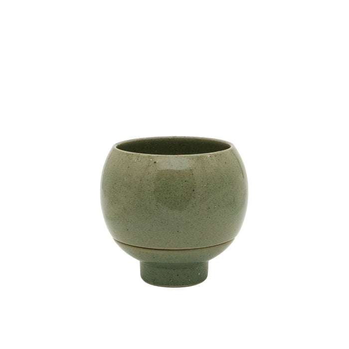 Green ceramic cup on a white background