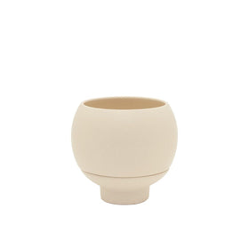 Beige ceramic cup on a white background