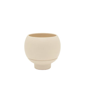 Beige ceramic cup on a white background