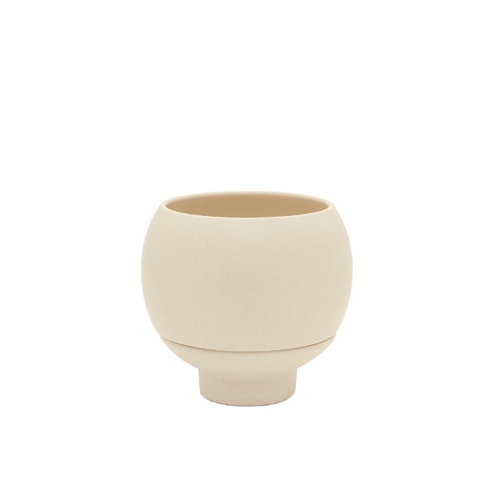 Beige ceramic cup on a white background