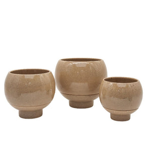 Three beige ceramic pots of varying sizes on a white background