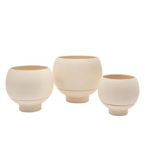 Three beige ceramic planters of different sizes on a white background