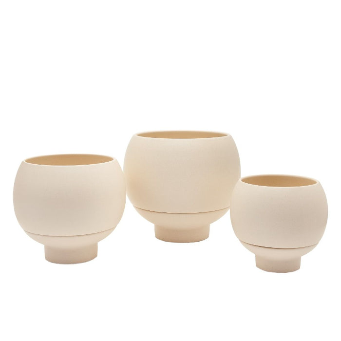 Three beige ceramic planters of different sizes on a white background