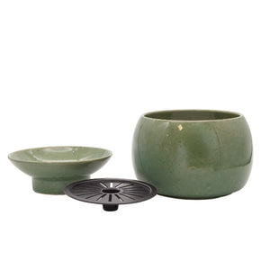 Set of green ceramic bowls on a white background